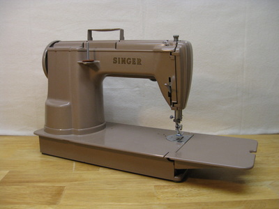 Singer 301 long bed sewing machine.  Mocha tan color.  Back side view. 